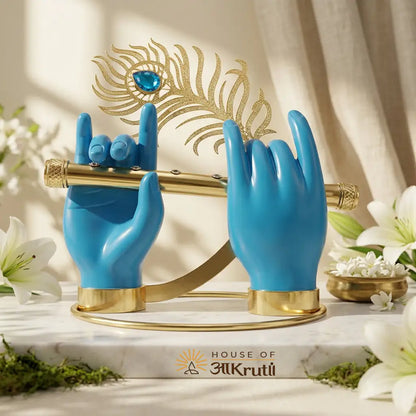 Blue hand-shaped holders with gold accents on a marble surface, featuring the House of Aakrutii logo.